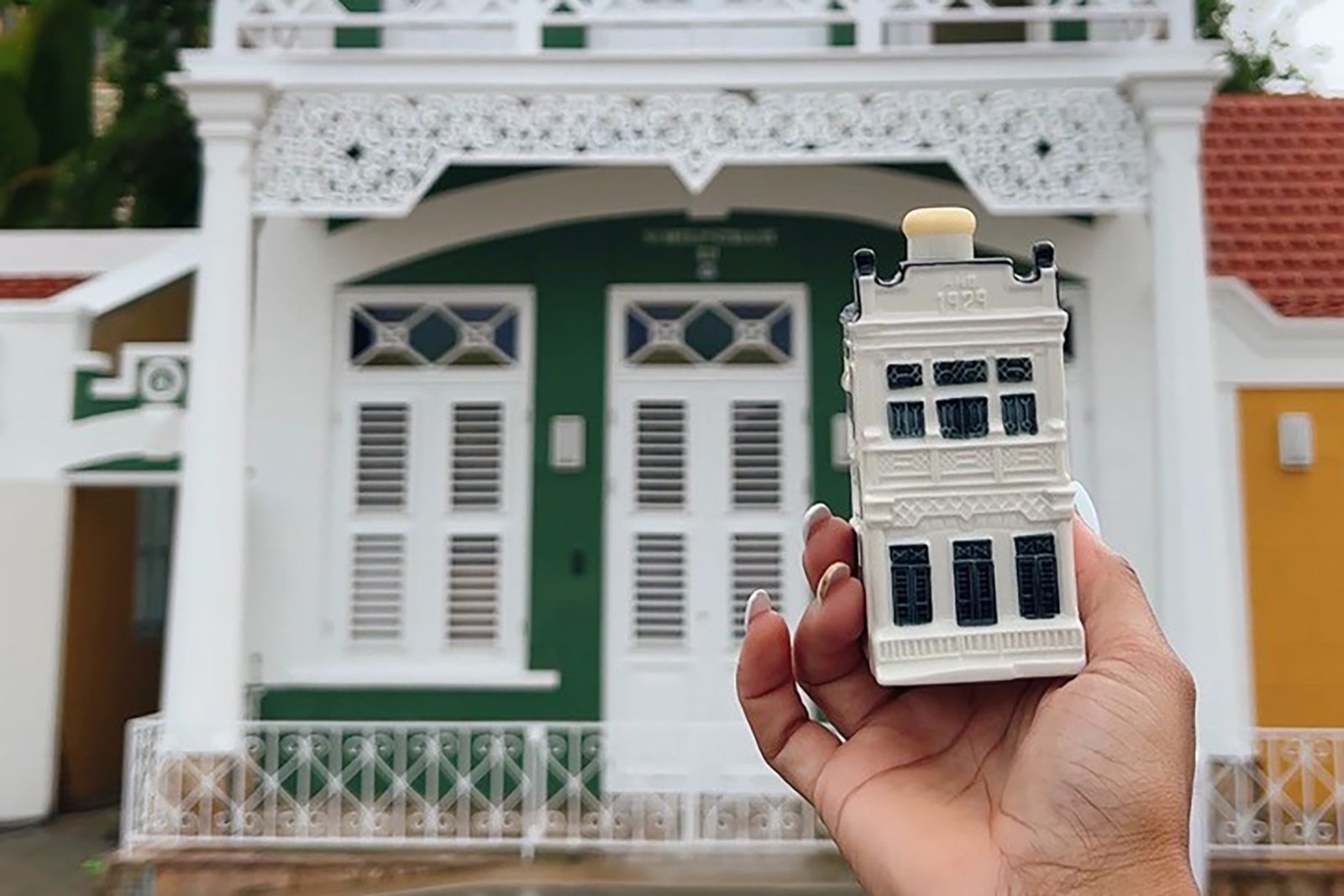 miniature house in front of real house