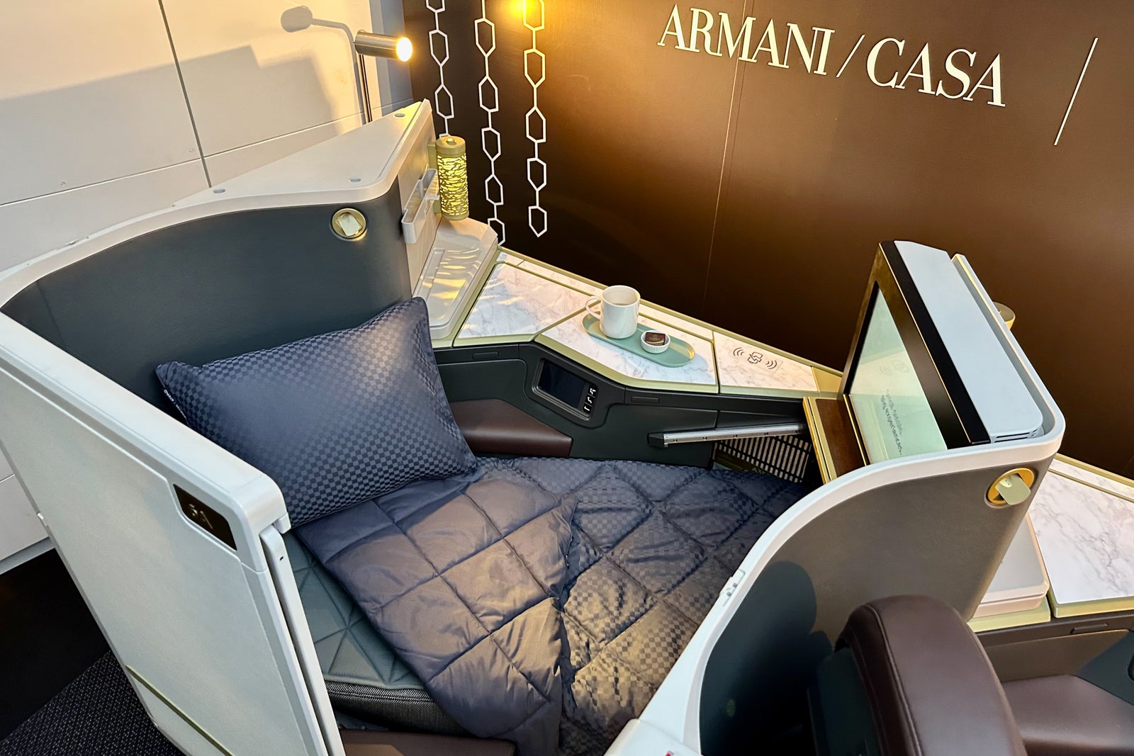lie-flat bed with Armani logo
