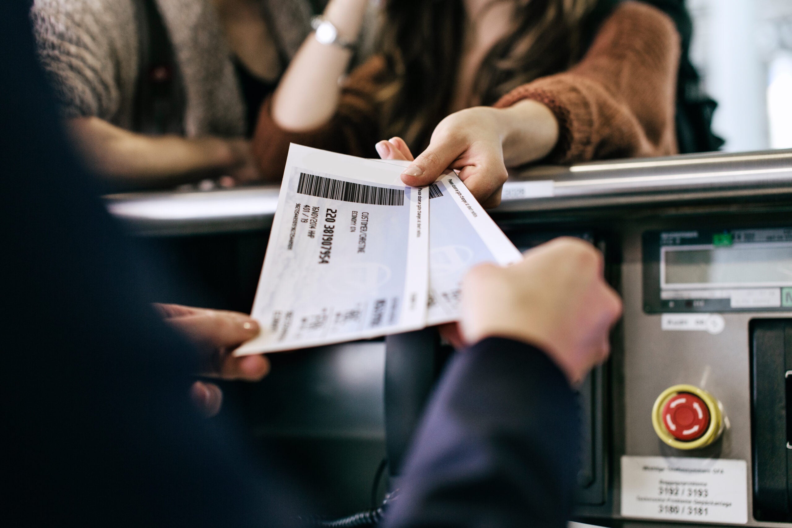 Travellers Getting Boarding Passes At Check-In