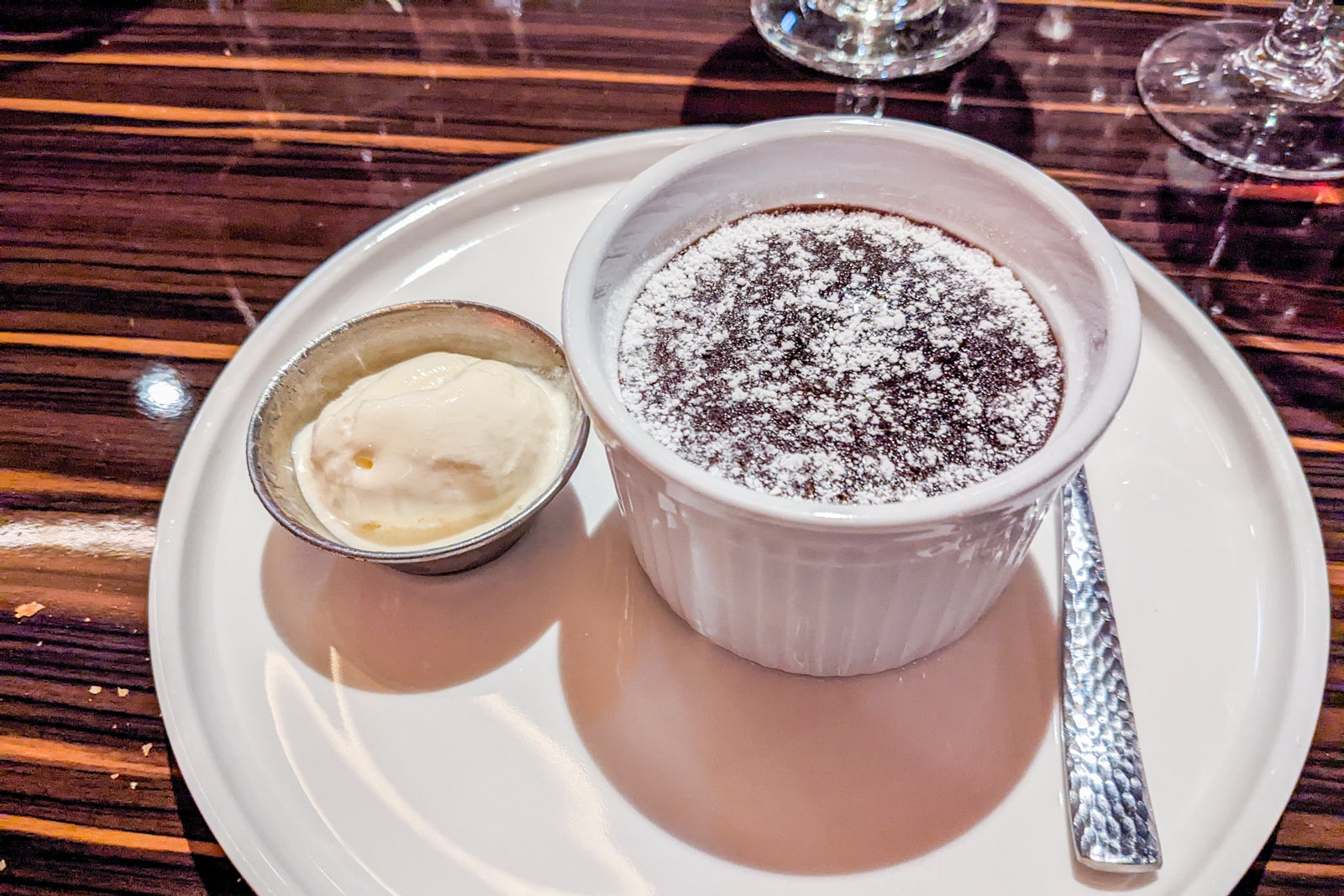 Chocolate melting cake in ramekin with scoop of ice cream on Carnival cruise