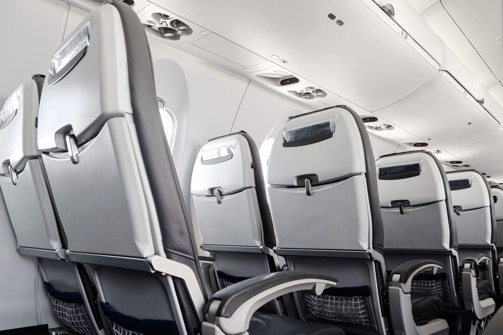Empty airplane seats in second class on an international flight during August peak season