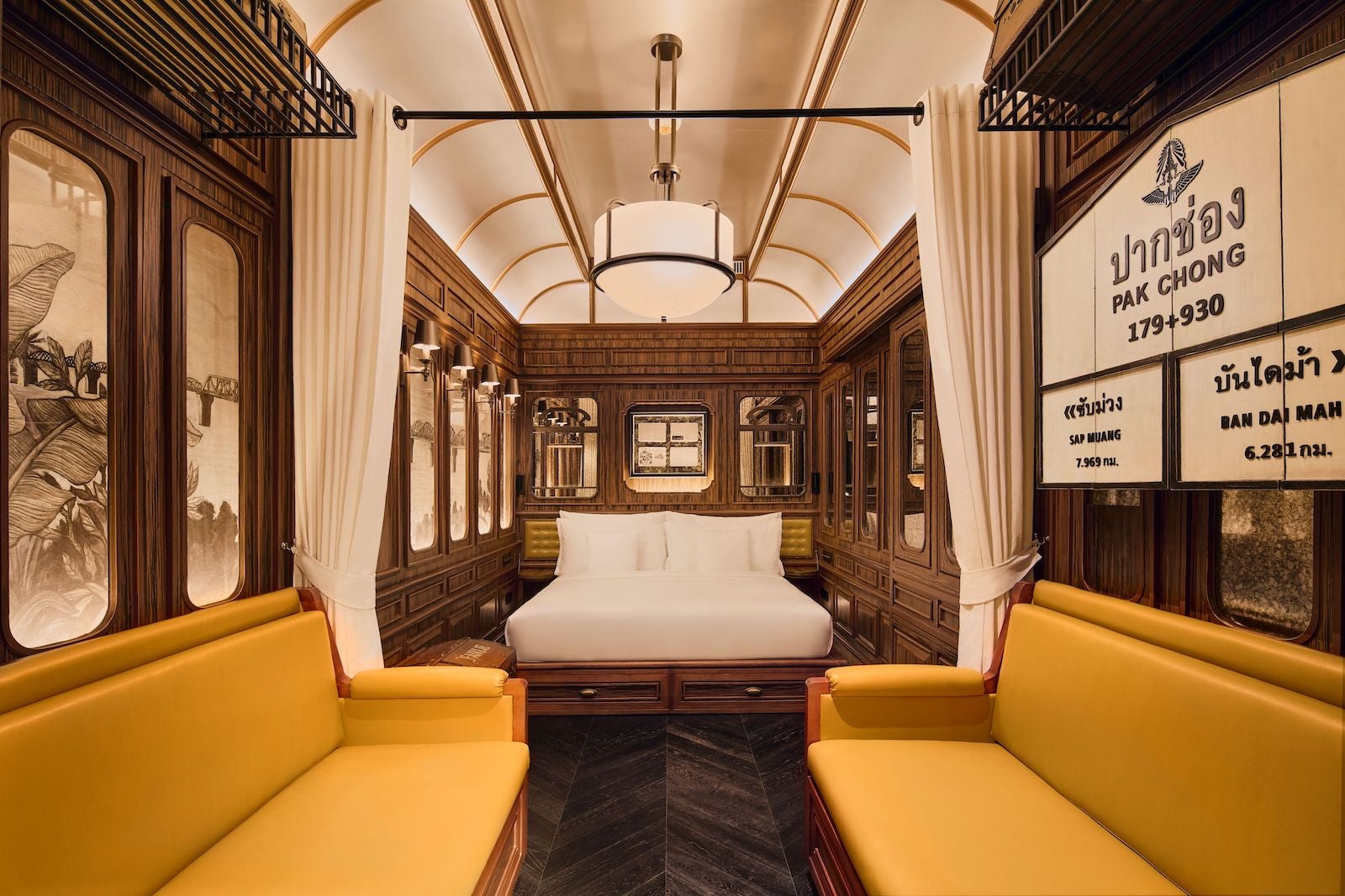 yellow couches flanking bed in train car