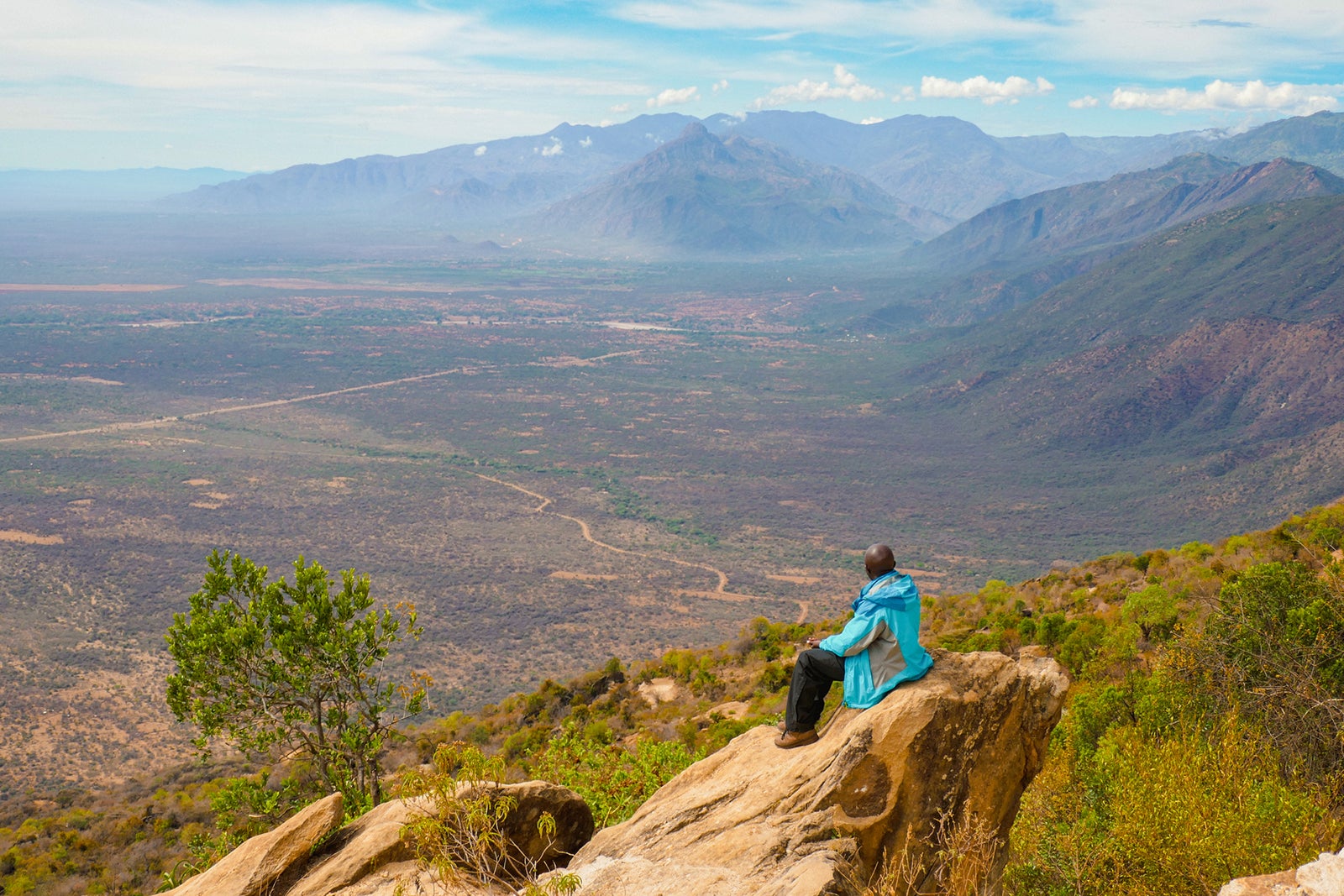 Side View Of A Hiker On A View Point Against A Mountain Range In West Pokot, Kenya