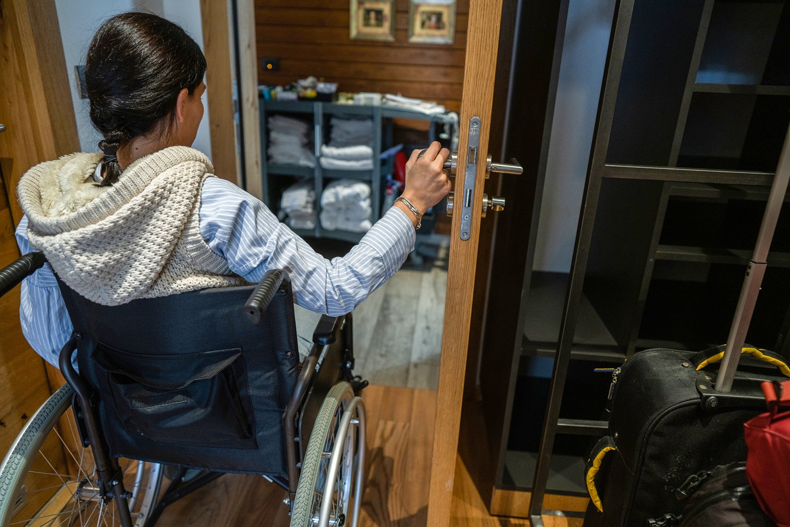 Disabled woman in wheelchair leaving hotel room