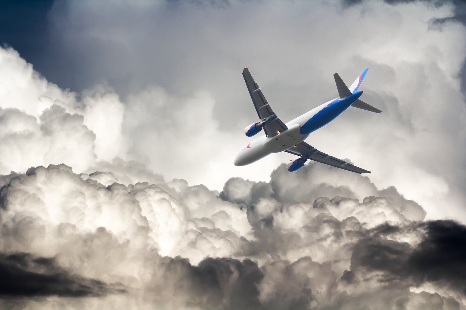 A commercial airplane flies through storm clouds