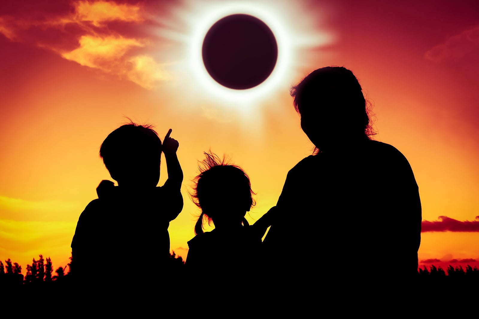 Natural phenomenon. Silhouette of family sitting and relaxing together.