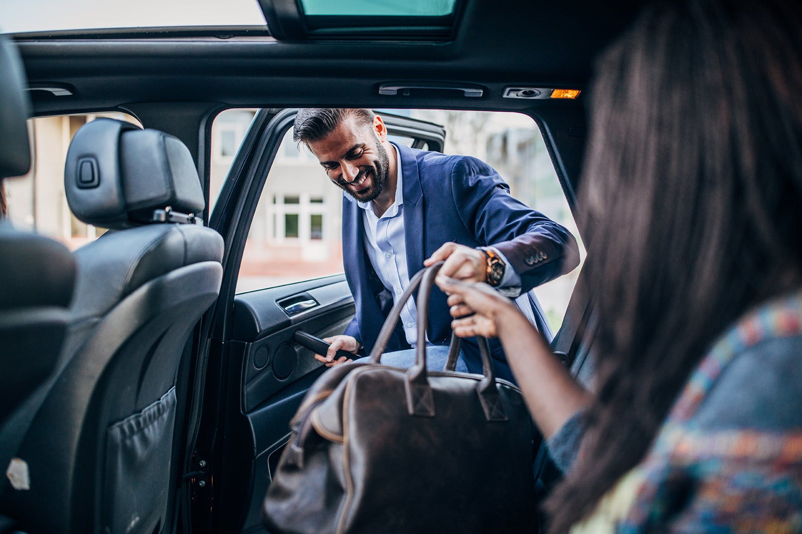 Young couple traveling by a car