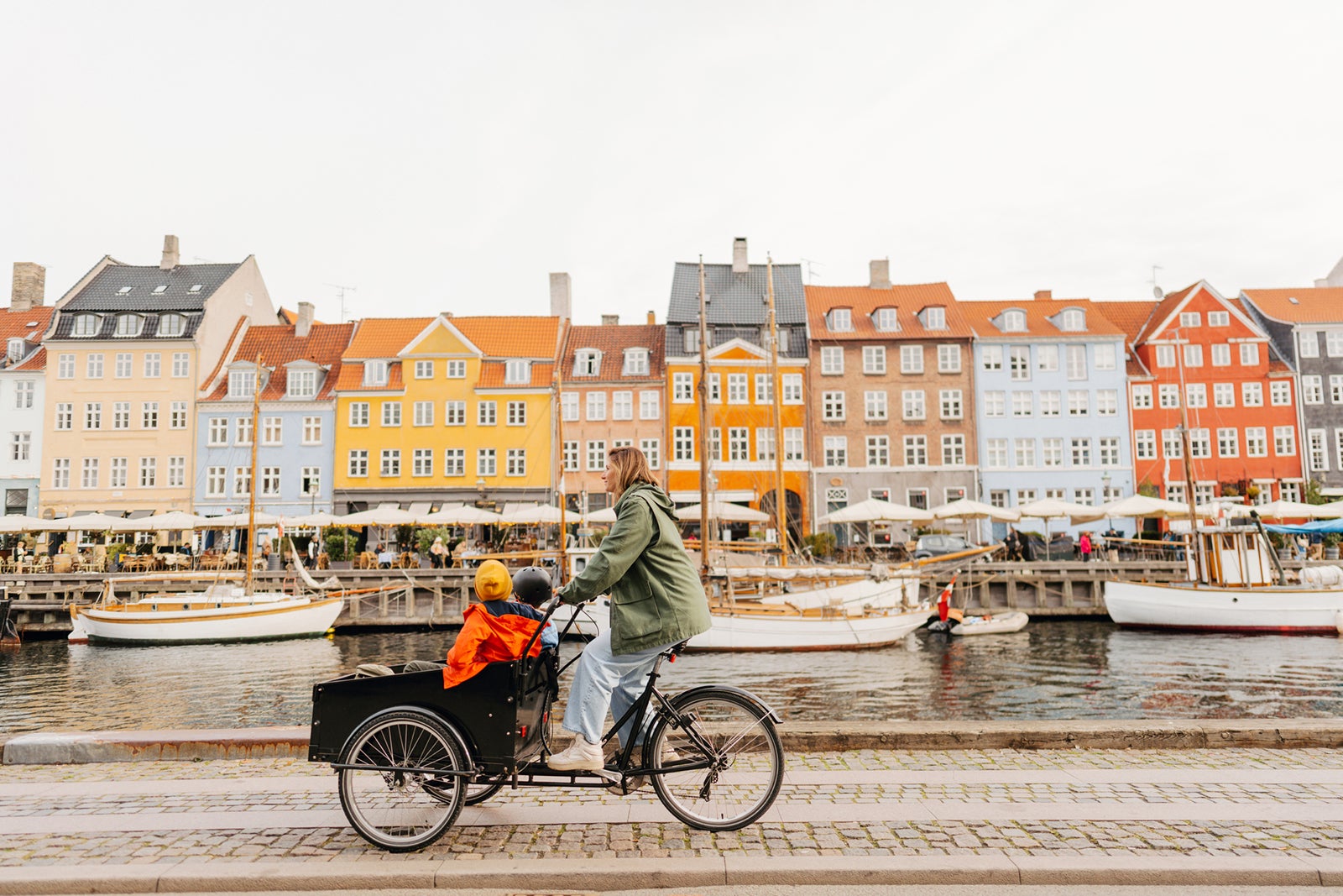 https://thepointsguy.global.ssl.fastly.net/us/originals/2023/08/Kids-cargo-bike-ride-with-mom-in-downtown-Copenhagen_-AleksandarNakic.jpg