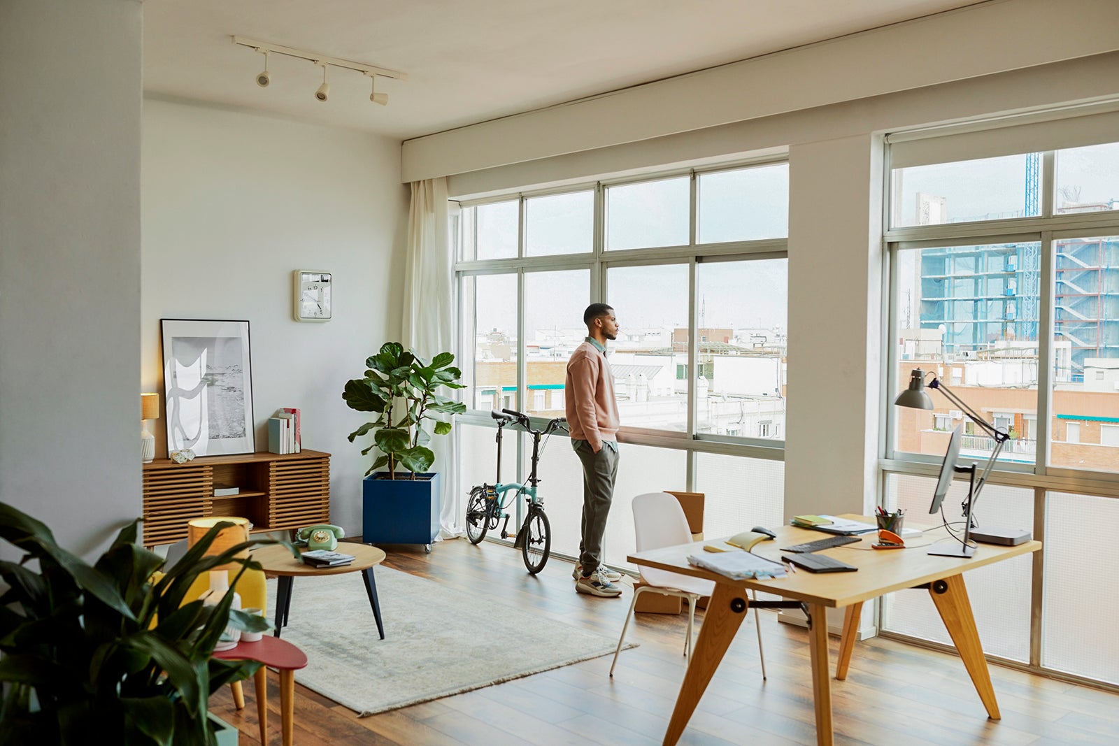 Man With Hands In Pockets Looking Through Window