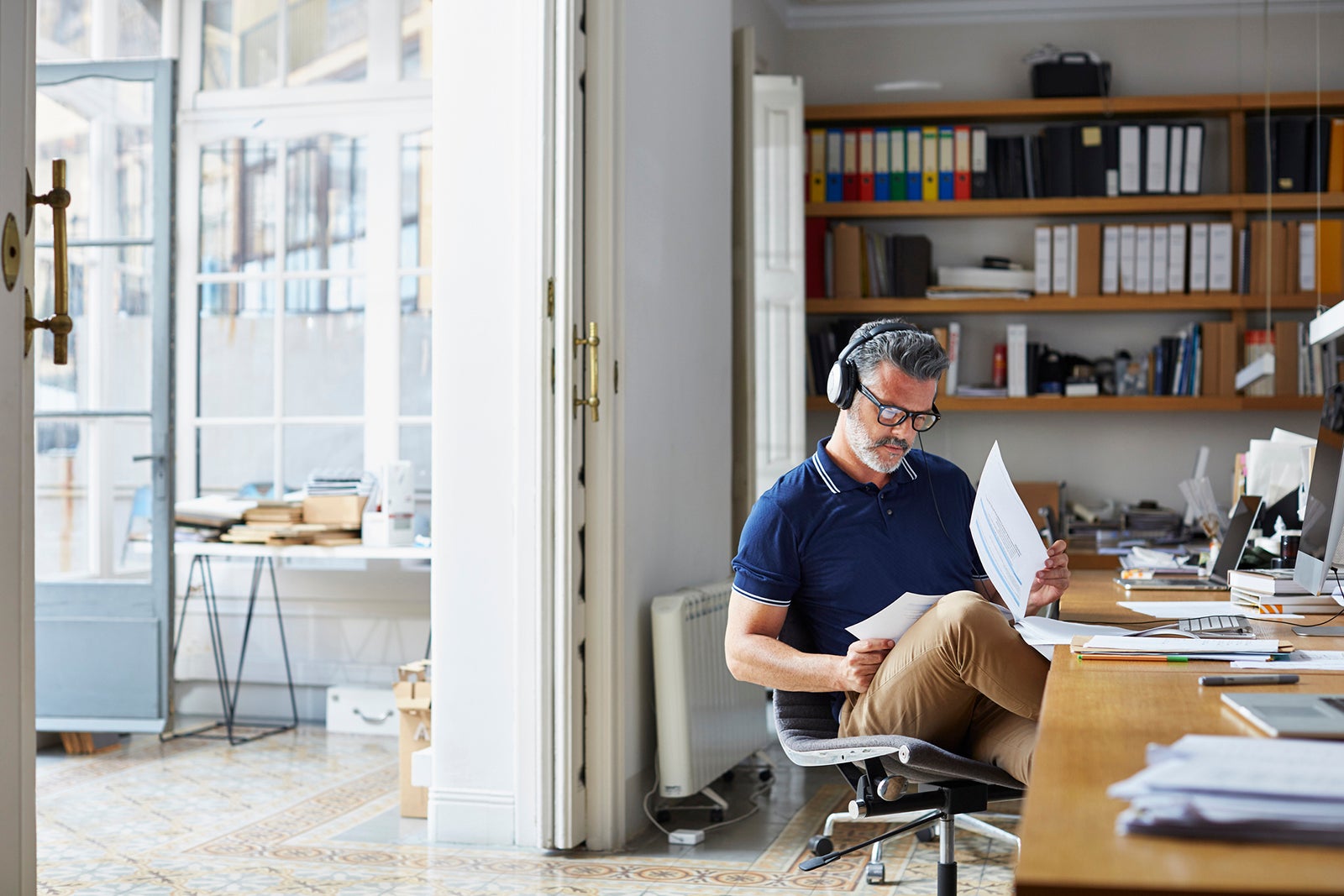 Businessman examining documents at desk