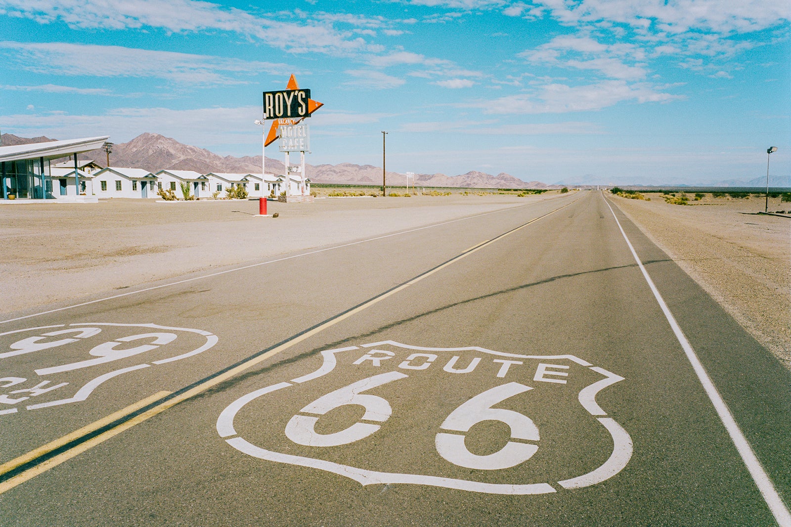 Roue 66 sign in road  by a Diner in the desert