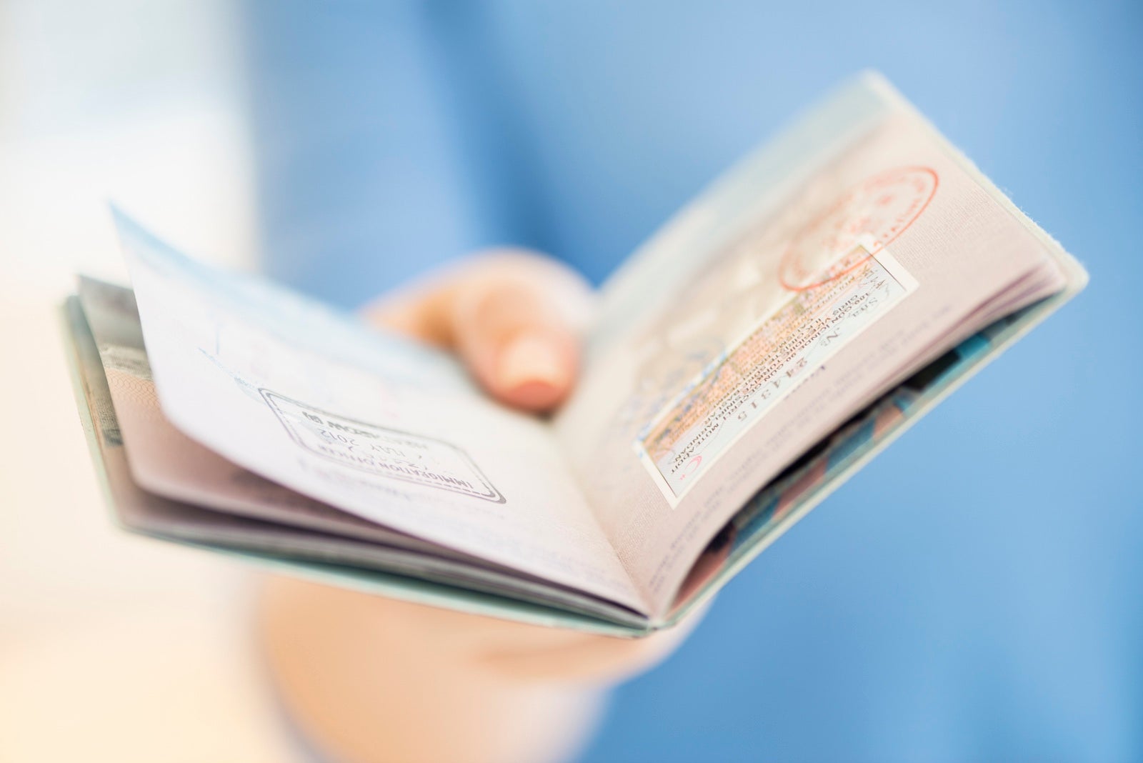 USA, New Jersey, Jersey City, Close up of woman's hand holding open passport