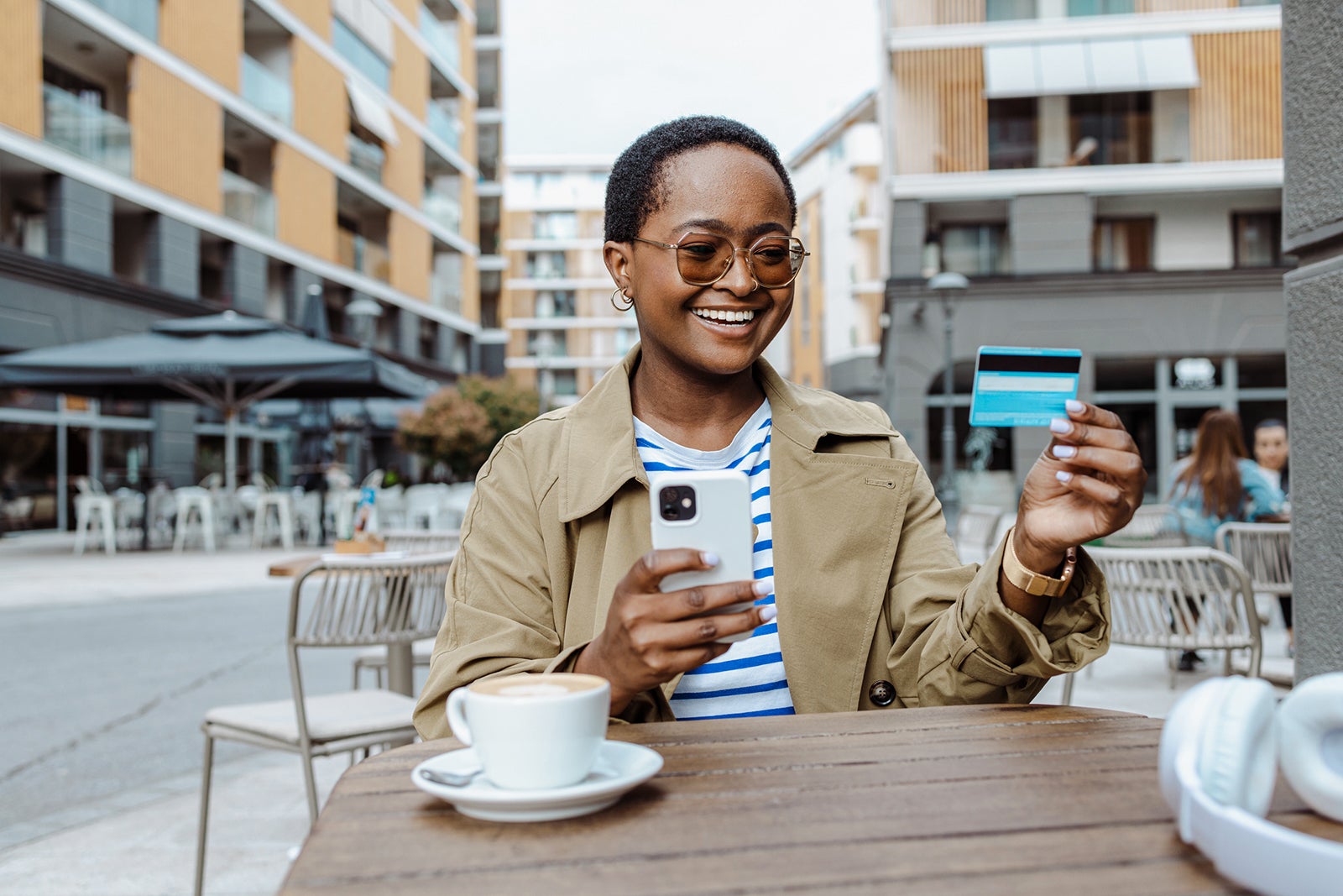 Portrait of a young Black woman using a smart phone to shop online