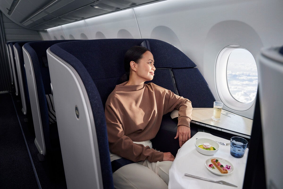 Finnair_A350_business_class_woman_with_salmon_dish_looking_out_window (1)