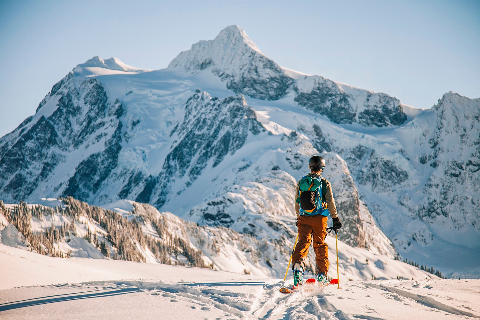A skier crosses a snowfield.
