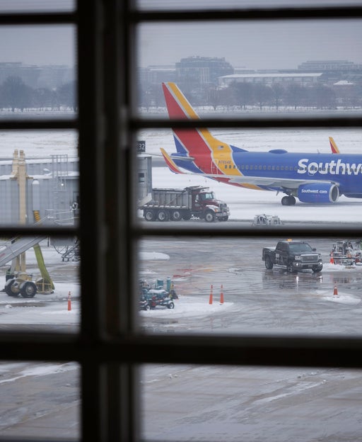 Monday's flight delays and cancellations top 10,000 as winter weather slams East Coast