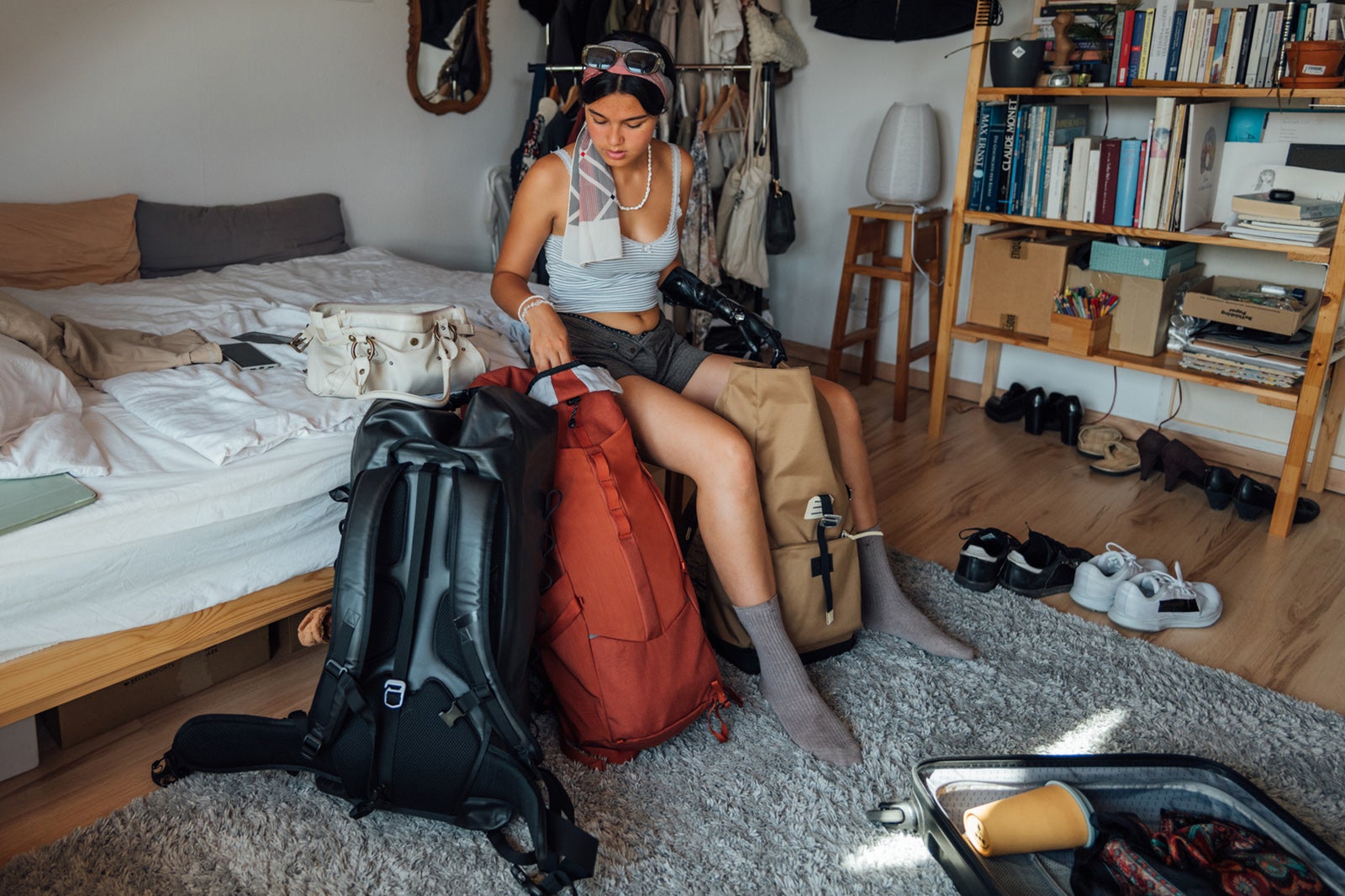 Person choosing luggage and packing for vacation in backpacks Counter